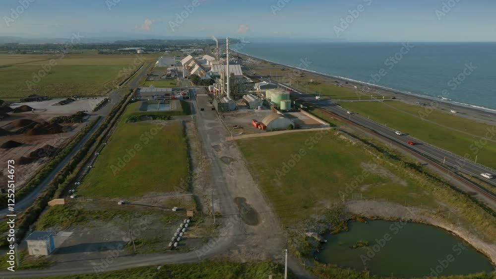 Industrial complex by the ocean. Factory buildings, roads, and vehicles. Coastal New Zealand. Waitangi Regional Park, Napier, Hawkes Bay, New Zealand Industrial complex by the ocean. Factory buildings, roads, and vehicles. Coastal New Zealand. Waitangi Regional Park, Napier, Hawkes Bay, New Zealand
