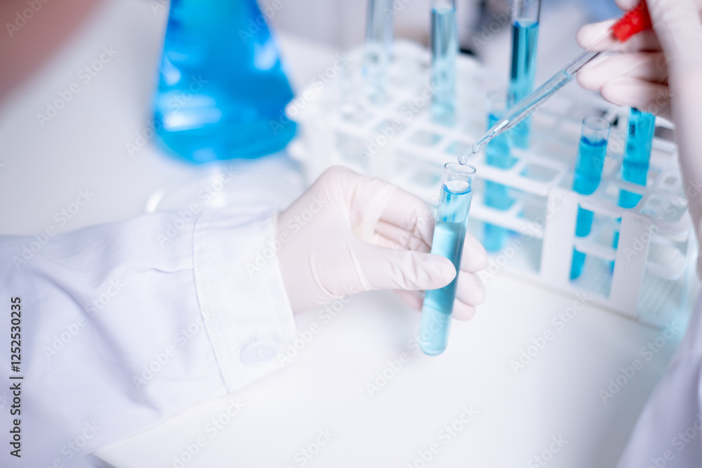 Close-up scientist pipette drop to test tube laboratory research chemistry chemical science research Close-up scientist pipette drop to test tube laboratory research chemistry chemical science research