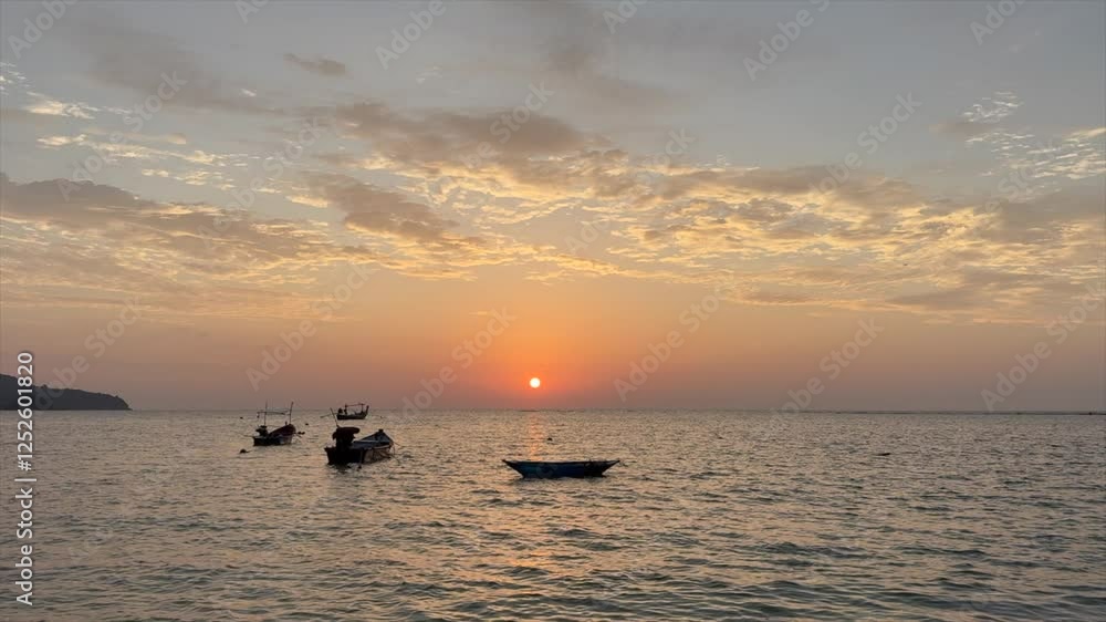 Sunset landscape on the coast of Phuket, Thailand - fishing boats silhouettes Sunset landscape on the coast of Phuket, Thailand - fishing boats silhouettes