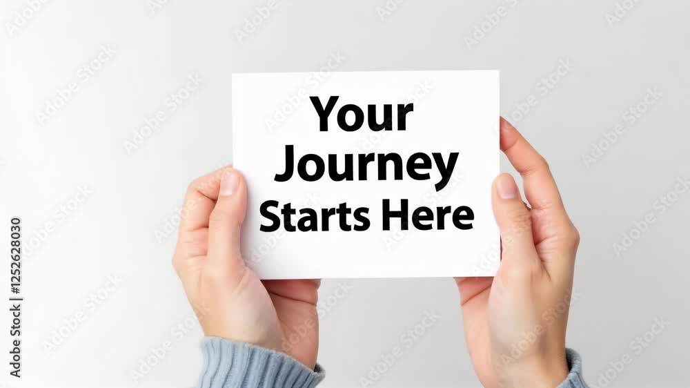 Hands Holding White Card with Your Journey Starts Here Text Hands Holding White Card with Your Journey Starts Here Text