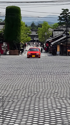 Red Car on Patterned Street...