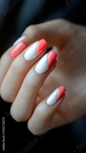 Stylish bright pink and white long nail design showcased on a manicured hand ...