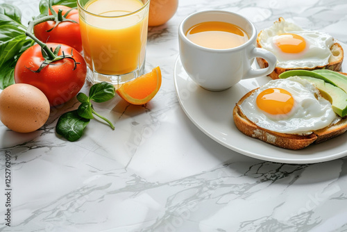 Breakfast table with fried eggs on toast, orange juice, and fres photo