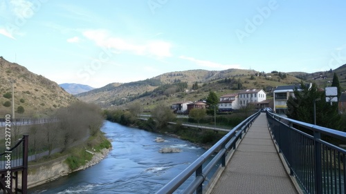 Wallpaper Mural Narrow pedestrian bridge overlooking a gentle river flowing through a picturesque valley, river valley, scenic views Torontodigital.ca
