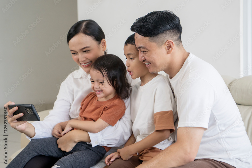 Happy Family Watching a Video on Smartphone Together Happy Family Watching a Video on Smartphone Together