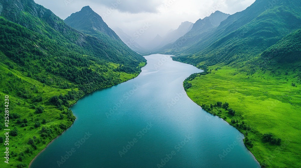 Fototapeta premium Alpine lake nestled in lush valley, aerial view