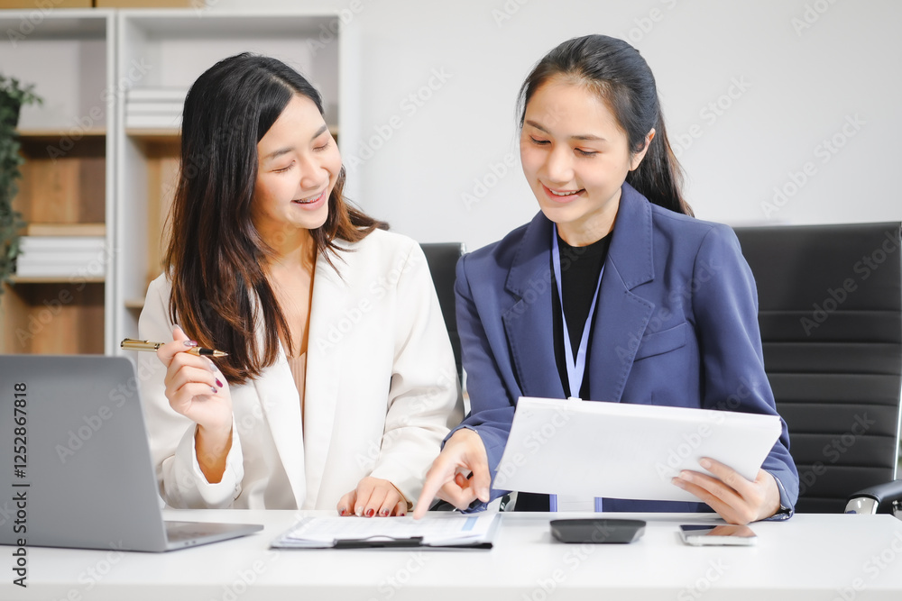 Two Asian female business woman sit desk,discussing business investments.They analyze financial data, explore market opportunities, and strategic growth to maximize returns ensure business success Two Asian female business woman sit desk,discussing business investments.They analyze financial data, explore market opportunities, and strategic growth to maximize returns ensure business success