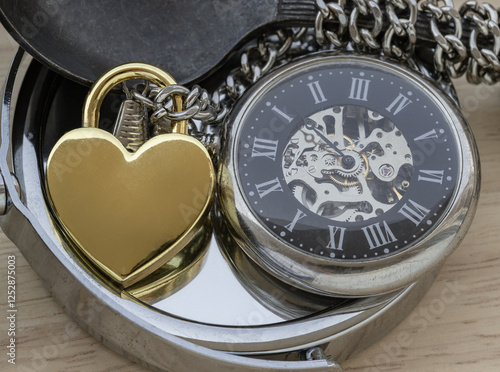 Golden heart shaped love padlock and A retro pocket watch on round mirror. Love can endure beyond the limitations of time, Concept of Love that transcends time, Valentine's day, use it as your Space.