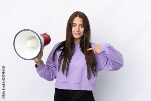 Young Ukrainian woman isolated on white background holding a megaphone and with surprise facial expression photo