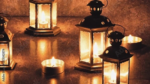 Multiple decorative lanterns glowing softly on dark surface
