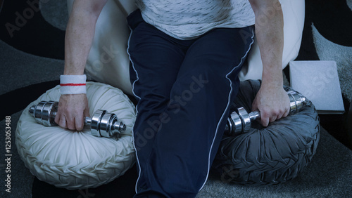 Obraz na płótnie Exercising at home with dumbbells and books w salonie