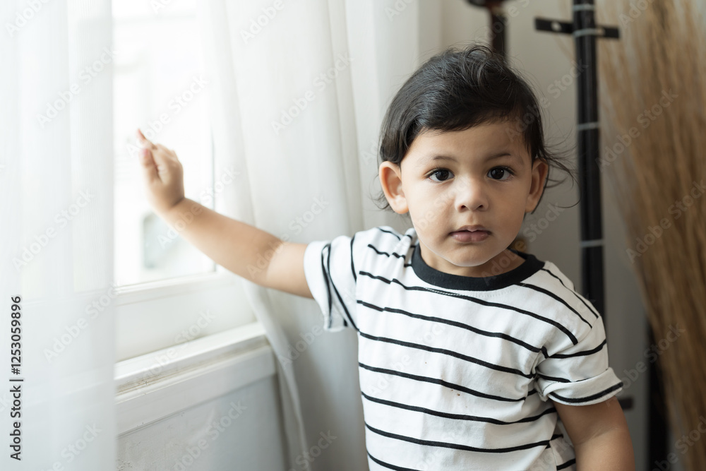 Cute little toddler boy playing in living room at home Cute little toddler boy playing in living room at home