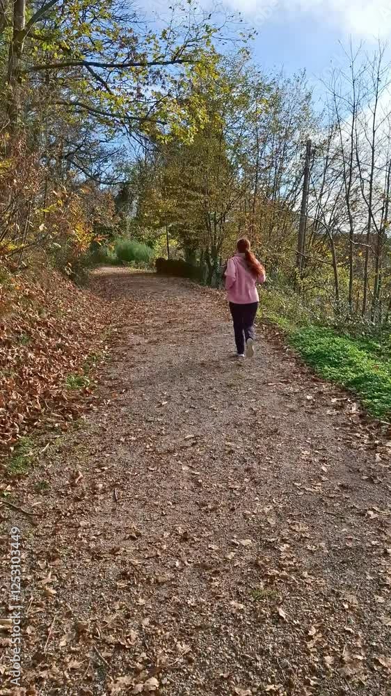 young woman running in the autumn park in the morning. sport in daily life.