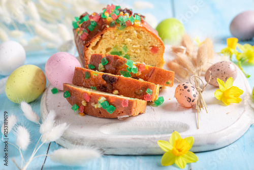 Fresh Fruitcake for Easter surrounded by spring flowers aand eggs. photo