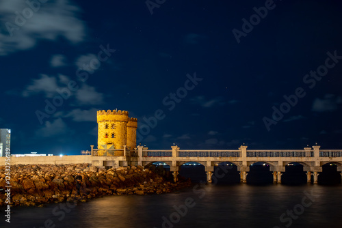 Alexandria, Egypt A night view of ancient stone towers at the Qaitbay Citadel on the Corniche. photo