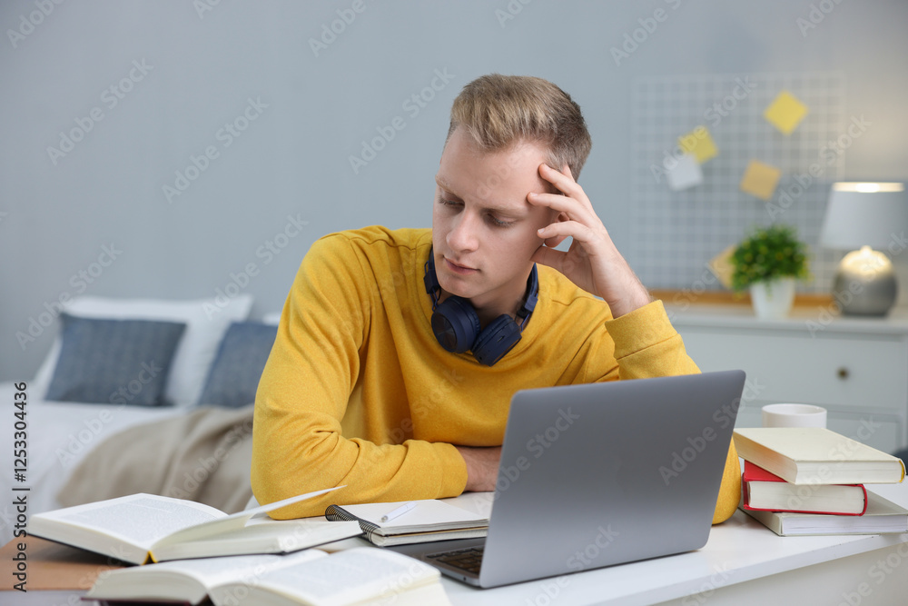 Student preparing for exam at table indoors Student preparing for exam at table indoors