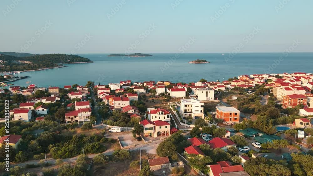 Aerial view of Rogoznica, Croatia. Coastal town with red-roofed houses and Adriatic Sea. Scenic Mediterranean landscape. Concept of summer holidays, travel and tourism Aerial view of Rogoznica, Croatia. Coastal town with red-roofed houses and Adriatic Sea. Scenic Mediterranean landscape. Concept of summer holidays, travel and tourism