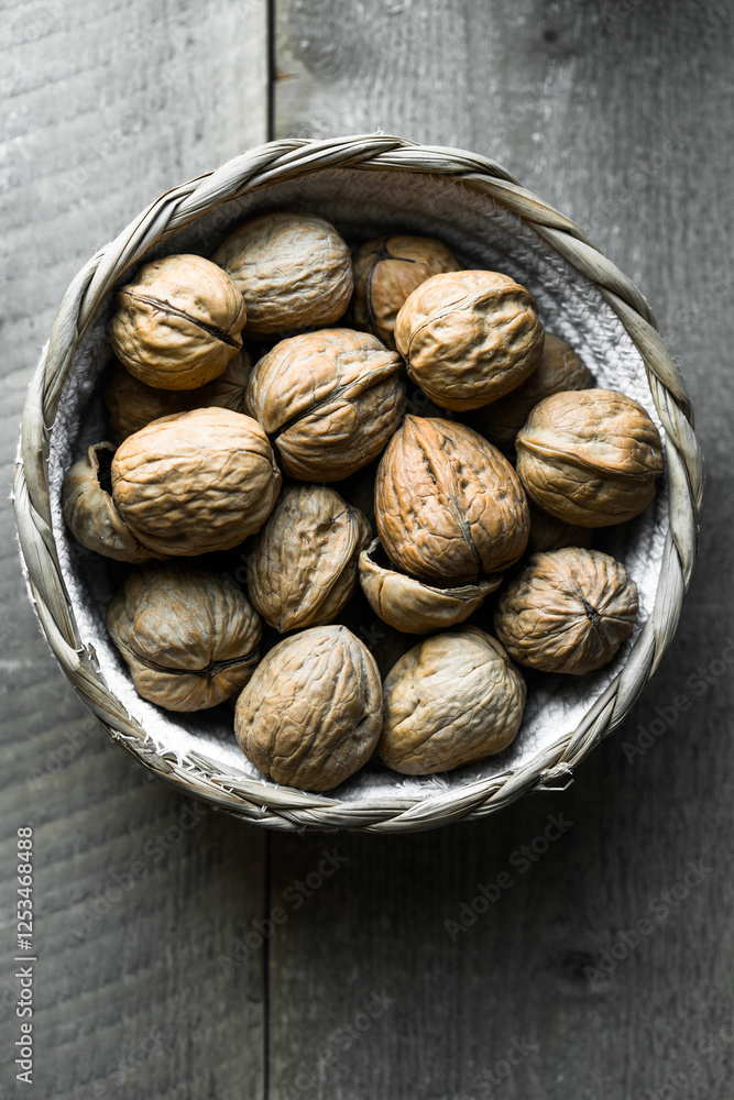 Raw walnuts in baskets on wooden Rustic table. Top view. Raw walnuts in baskets on wooden Rustic table. Top view.