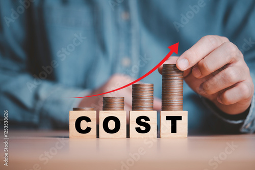 Businessman putting coins with up arrow  for cost increasing in factory and business cost concept.
