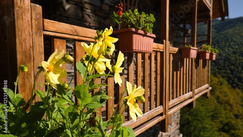 Wooden balcony with yellow flowers photo