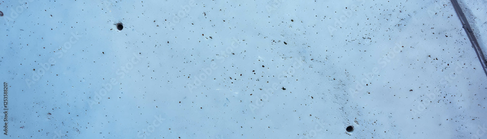 Poured cement with a smooth and glossy surface featuring subtle imperfections and bright background