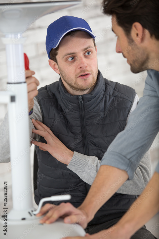 electrician with apprentice working in new home electrician with apprentice working in new home