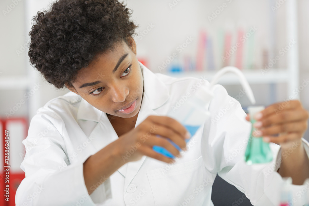 doctor or student compares two liquids in lab doctor or student compares two liquids in lab