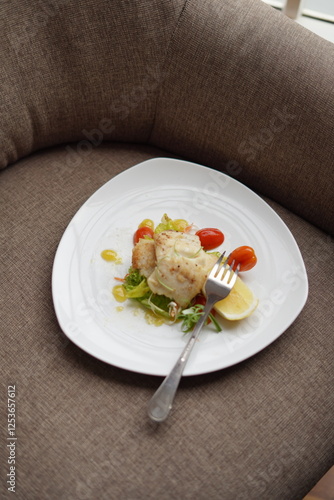 Plated Salmon Fish Dish with Salad and Lemon Garnish