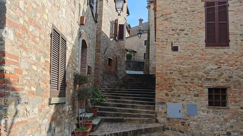 Italy, umbria. stairs leading up with flowers decorating the homes in the historic town of montone