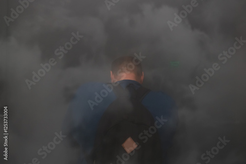 man in a burning building shrouded in smoke