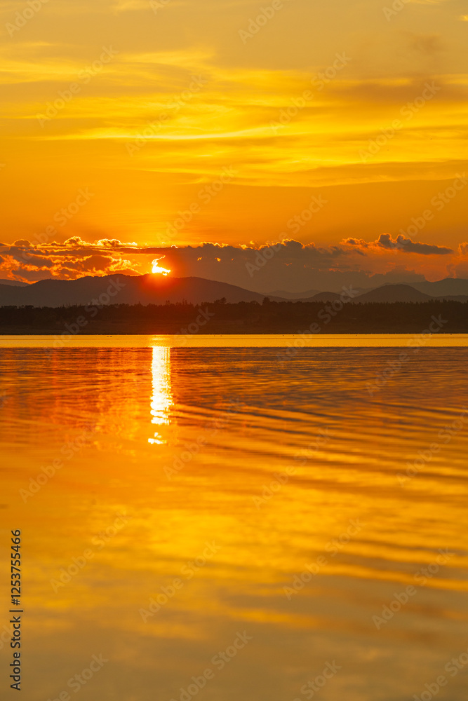 Landscape of mountains and lake at sunset and clouds reflected in the water. Landscape of mountains and lake at sunset and clouds reflected in the water.