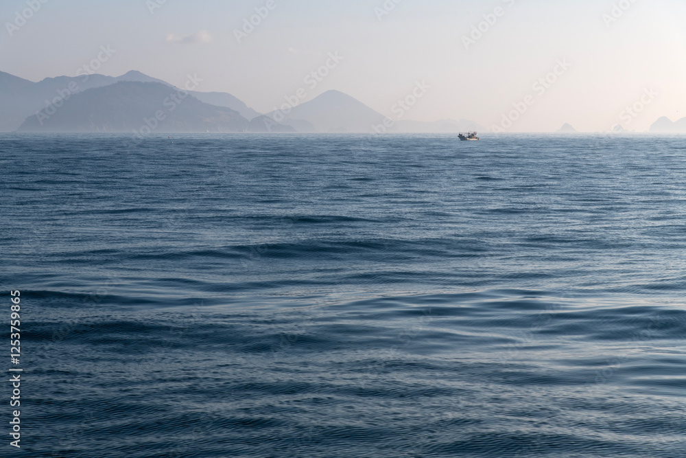 fishing boat with fog on the sea at dawn fishing boat with fog on the sea at dawn