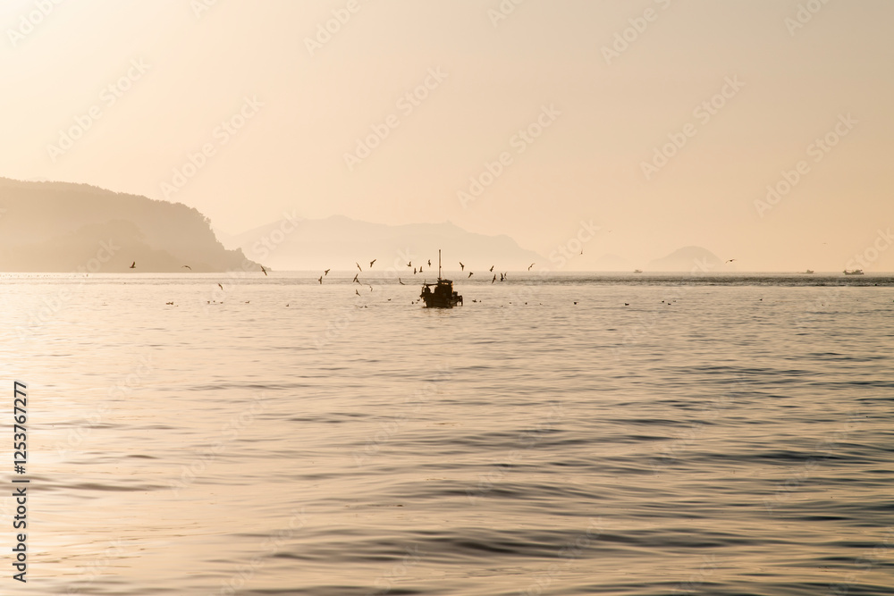 fishing boat with fog on the sea at dawn fishing boat with fog on the sea at dawn