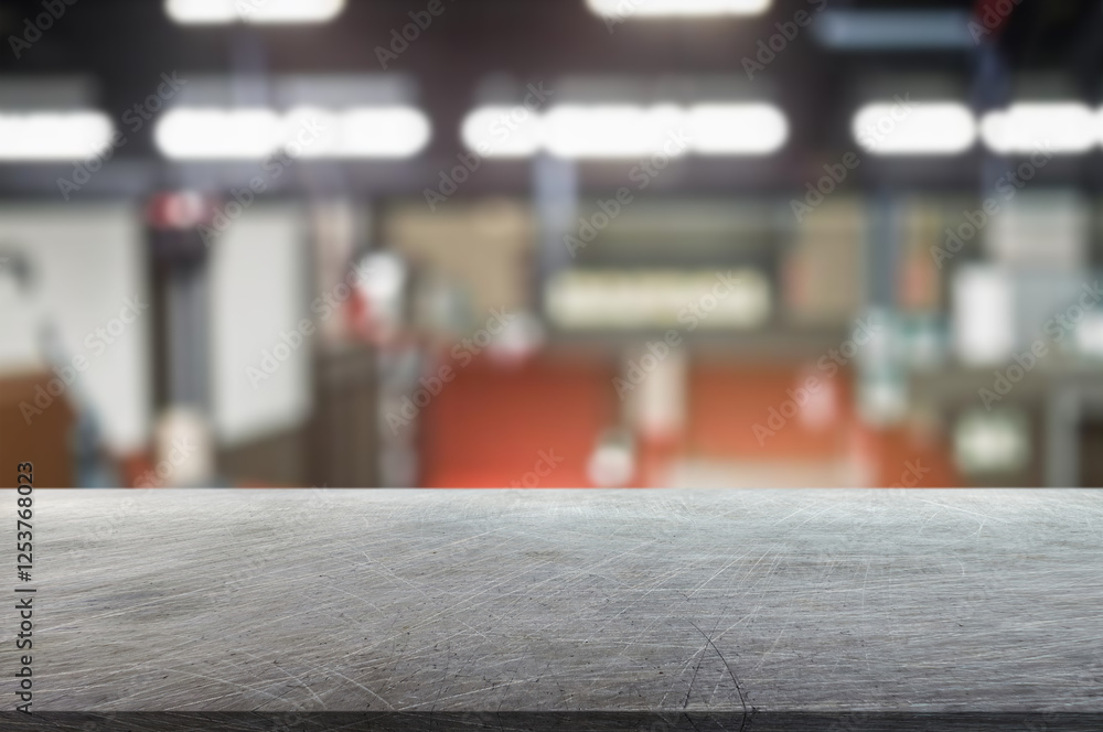 Obraz premium blurred background of factory and empty steel tabletop in foreground. Business presentation