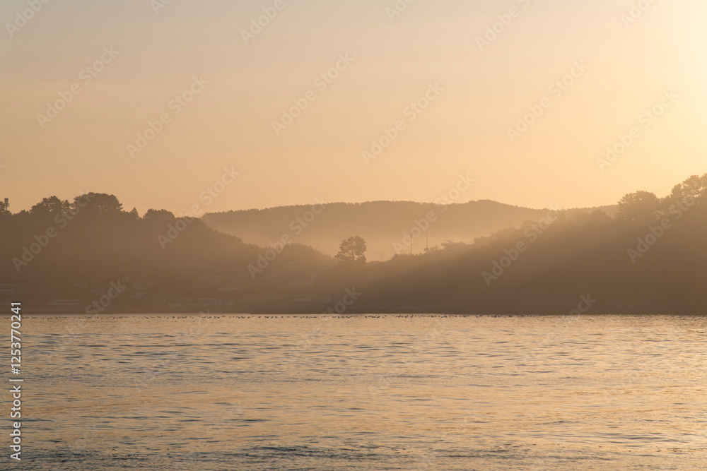 sea and island with fog at dawn
