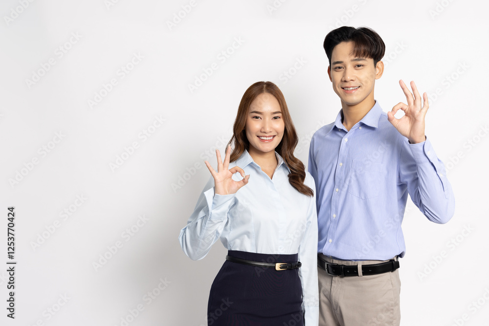 Portrait of young Asian couple showing ok sign isolated on white background, Businessman and Businesswoman concept Portrait of young Asian couple showing ok sign isolated on white background, Businessman and Businesswoman concept