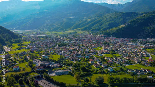 Aerial view of the town of Borgo Valsugana amidst the greenery of the mountains. Wonderful valley in Trentino, Italy