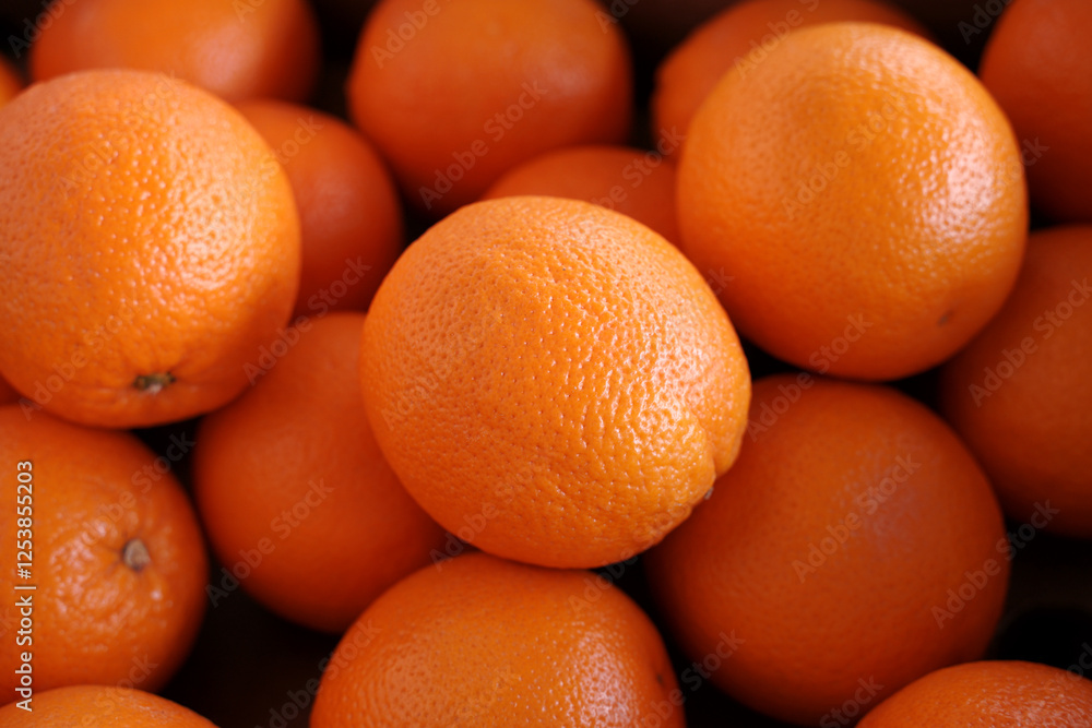 Oranges close up. Fresh orange fruits as background. Selective focus. Whole fresh ripe oranges on a black background. Oranges close up. Fresh orange fruits as background. Selective focus. Whole fresh ripe oranges on a black background.