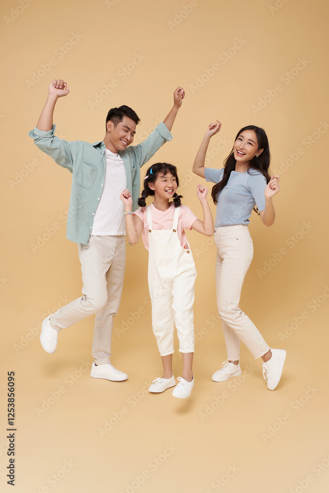 Portrait happy smiling Asian family fun hand up celebrate winner together isolated on nude color background. Portrait happy smiling Asian family fun hand up celebrate winner together isolated on nude color background.