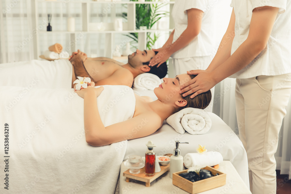 Obraz premium Caucasian couple enjoying relaxing anti-stress head massage and pampering facial beauty skin recreation leisure in dayspa modern light ambient at luxury resort or hotel spa salon. Quiescent