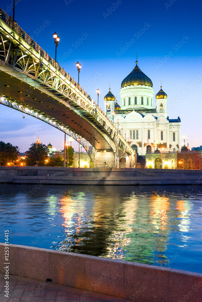 The Orthodox Cathedral of Christ the Savior and the Patriarchal bridge over the night Moskva River. Moscow