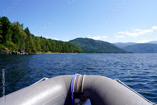 Inflatable boat adventure on the lake around the hills photo