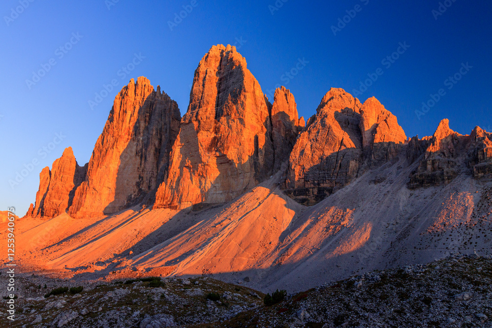 north side of Tre Cime di Lavaredo in the sextner dolomites during sunset with warm golden light golen hour