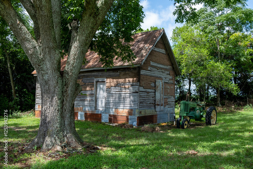 old wooden house and farm tractor