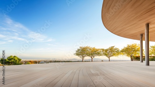 Serene Outdoor Space with Wooden Deck, Modern Architecture, and Scenic View of Trees, Hills, and Clear Blue Sky at Dusk or Dawn photo