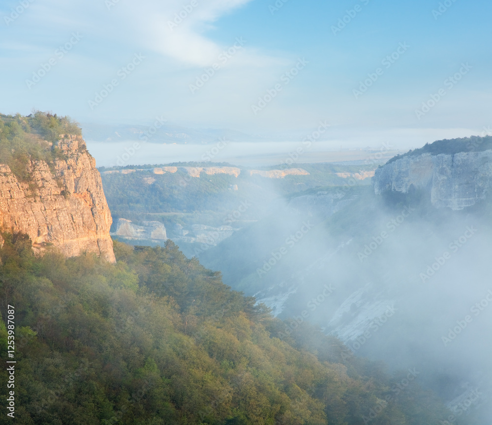 Morning cloudy view from top of Mangup Kale - historic fortress and ancient cave settlement in Crimea (Ukraine) Morning cloudy view from top of Mangup Kale - historic fortress and ancient cave settlement in Crimea (Ukraine)