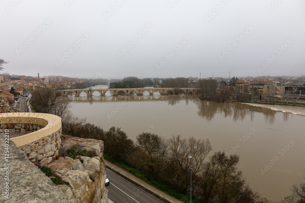 Scenic View of a Foggy River Duero in Zamora Spain and Historic Bridge Scenic View of a Foggy River Duero in Zamora Spain and Historic Bridge