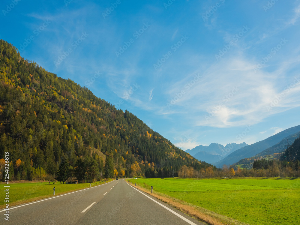 Naklejka premium bright autumn landscape, view of the Austrian Alps. road to Italy on sunny day.