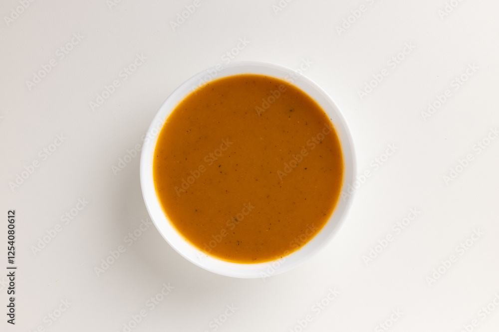 A top view of a round white bowl filled with winter vegetable purée, set against a white background. Simple, clean design, perfect for food styling, product mockups, or promotional use. A top view of a round white bowl filled with winter vegetable purée, set against a white background. Simple, clean design, perfect for food styling, product mockups, or promotional use.