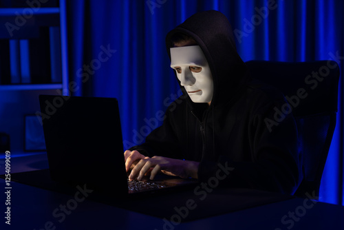 White criminal anonymous mask installing coding password encryption by programming hack, trying to make insecure thorough privacy taking massive database on computer for ransom to company. Pecuniary. photo